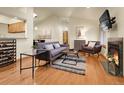 Open living space features hardwood floors, vaulted ceilings, and a modern fireplace at 6321 S Harrison Ct, Centennial, CO 80121