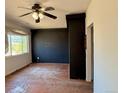 Empty living room features a ceiling fan and a large window for natural light at 240 N 4Th Ave, Brighton, CO 80601