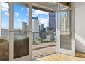 Balcony with a stunning cityscape view from floor-to-ceiling glass doors at 2020 Arapahoe St # 970, Denver, CO 80205
