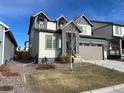 Two-story house with gray and blue exterior, attached garage, and landscaping at 27869 E 7Th Pl, Aurora, CO 80018