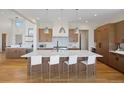 A gourmet kitchen with a large island, stainless appliances, and custom cabinetry at 6176 Oxford Peak Ln, Castle Rock, CO 80108