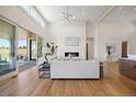 Open-concept living space with hardwood floors, fireplace, and access to the outdoor patio at 6176 Oxford Peak Ln, Castle Rock, CO 80108