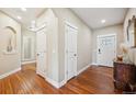 Inviting entryway featuring gleaming wood floors, white doors, and decorative mirrors for added elegance at 9744 W Ontario Pl, Littleton, CO 80128