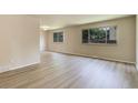 Bright living room featuring neutral walls, large windows and laminate flooring at 633 S Galena St, Denver, CO 80247