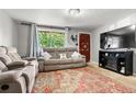 Comfortable living room with a large window and fireplace at 8960 Judson St, Westminster, CO 80031