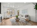 Bright living room with hardwood floors, fireplace, and large windows at 2569 Forest St, Denver, CO 80207