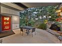 Relaxing outdoor patio area with a waterfall feature, comfortable seating, and lush landscaping, perfect for entertaining guests at 812 Aspen Rd, Golden, CO 80401