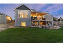 The exterior showcases a spacious backyard with a covered deck, lower patio, and a well-maintained lawn at 5181 Appleton Way, Castle Rock, CO 80104