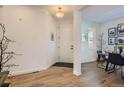 Bright foyer features hardwood floors and access to the dining area at 8137 Ralston Creek Ave, Littleton, CO 80125