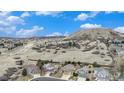 Scenic view of homes in a neighborhood with rolling hills in the background at 1479 Short Grass Ct, Castle Rock, CO 80109