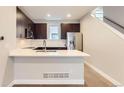 Modern kitchen featuring quartz counters, stainless steel appliances, and an island with seating at 3150 Vallejo St, Denver, CO 80211