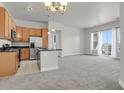Bright, open-concept living space with modern finishes and an open kitchen at 14321 E Tennessee Ave # 1-301, Aurora, CO 80012