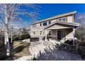 Backyard features a patio, grill, hot tub, stone features, and manicured lawn at 10761 Hillsboro Cir, Parker, CO 80134