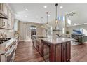 Open kitchen with island, wine cooler, modern countertops, and seamless flow to the living area at 10761 Hillsboro Cir, Parker, CO 80134
