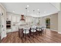 Bright kitchen featuring a large kitchen island with barstool seating and stainless steel appliances at 10761 Hillsboro Cir, Parker, CO 80134