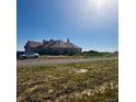 Beautiful single-story home with a car parked outside, set in an idyllic rural landscape at 13291 N Harback Rd, Bennett, CO 80102
