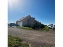 Tan house with an attached garage and an array of vehicles in the driveway at 13291 N Harback Rd, Bennett, CO 80102