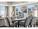 Open-concept space with dining table set for eight, great natural light, and city skyline views through large windows at 1411 Wynkoop St # 806, Denver, CO 80202