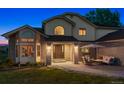 Charming front entrance with brick accents, a cozy seating area, and a well-manicured lawn at 7289 Stroh Rd, Parker, CO 80134