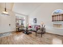 Bright living room featuring hardwood floors, large windows, and elegant seating arrangements at 9032 W Arizona Dr, Lakewood, CO 80232