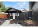 The private backyard features sleek, black-painted structures, a modern aesthetic, and potential for creative landscaping at 110 S Hoyt St, Lakewood, CO 80226