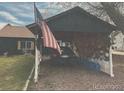 Car parked in rustic carport with USA flag, providing shelter and country charm at 110 S Hoyt St, Lakewood, CO 80226