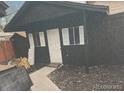 Exterior of storage shed featuring neutral siding, with white trimmed windows and door at 110 S Hoyt St, Lakewood, CO 80226
