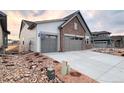 Charming home featuring a two-car garage, and professionally landscaped front yard with rock accents at 3856 Treadway Pt, Castle Rock, CO 80108