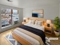 Virtually staged bedroom with large window and wood platform bed at 4450 S Pitkin St # 128, Aurora, CO 80015