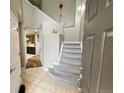 Bright and spacious entryway with staircase and view of kitchen at 23080 York Ave, Parker, CO 80138