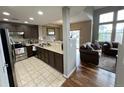 Kitchen with dark brown cabinets, stainless steel appliances, and tile flooring at 23080 York Ave, Parker, CO 80138
