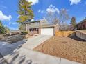 A beautiful 2-story home with a driveway and a well-maintained lawn at 6720 S Adams Way, Centennial, CO 80122