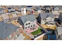 Aerial view of the home with a spacious fenced backyard, patio, and green lawn at 18284 E 52Nd Pl, Denver, CO 80249
