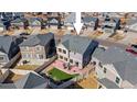 Overhead view of a well-kept home featuring fenced backyard, patio, and cozy seating area at 18284 E 52Nd Pl, Denver, CO 80249