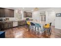 Spacious kitchen with a large island, stainless steel appliances, and hardwood floors at 1027 Auburn Dr, Erie, CO 80516