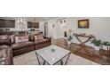 Open-concept living room with hardwood floors and plenty of natural light at 1027 Auburn Dr, Erie, CO 80516