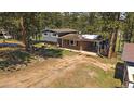 Charming home featuring a brick facade, a lush green yard, and a covered parking area at 29827 Gigi Rd, Evergreen, CO 80439