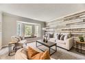 Cozy living room with a bay window and custom wood paneled wall at 16257 E Belleview Pl, Centennial, CO 80015