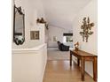 Inviting hallway features beautiful wood floors, vaulted ceilings and stylish decor at 22070 Day Star Dr, Parker, CO 80138