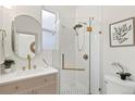 Updated bathroom with a walk-in shower, modern vanity, and gold fixtures at 2929 N Josephine St, Denver, CO 80205