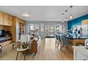 Bright living area with floor-to-ceiling sliding glass doors and bar seating at the kitchen island at 1438 Little Raven St # 310, Denver, CO 80202