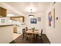 Cozy dining area featuring a four-seat dining table, a breakfast bar, and bright overhead lighting at 10293 E Peakview Ave # F104, Englewood, CO 80111