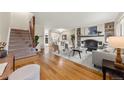Spacious living room with hardwood floors, fireplace, and staircase at 63 S Holman Way, Golden, CO 80401