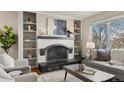 Cozy living room with a fireplace and built-in bookshelves at 63 S Holman Way, Golden, CO 80401