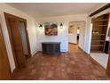 Inviting entry features striking terra cotta floors, warm wood trim, and artful details that create a welcoming ambiance at 2100 Robb St, Lakewood, CO 80215