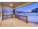 Covered porch with a view of a snow-covered neighborhood at 8512 Orchard City Dr, Littleton, CO 80125