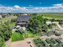 Gorgeous backyard with a two-story deck, patio, and charming garden with fresh produce at 34827 E 7Th Ave, Watkins, CO 80137