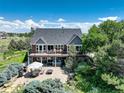 Enjoy outdoor living with a spacious deck, patio area, BBQ, and a relaxing hot tub at 34827 E 7Th Ave, Watkins, CO 80137