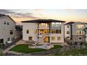 Stylish two-story home with a backyard patio and outdoor fireplace at 7611 Copper Sky Ct, Castle Pines, CO 80108