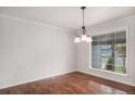 Bright dining room with hardwood floors and a large window with natural light at 1962 S Ivory Way, Aurora, CO 80013